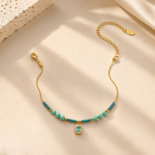 Close-up of water-resistant titanium steel anklet with blue beads and sparkling zirconia.