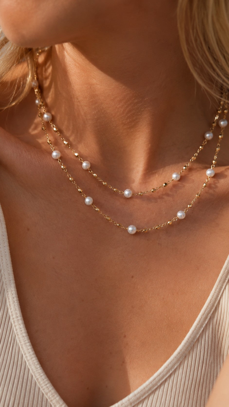 Model showcasing 80cm freshwater pearl station necklace wrapped twice as a double-layer short choker