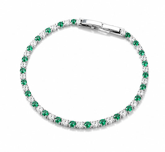 Detailed view of an elegant emerald green and clear zirconia tennis bracelet in a white gold-tone finish.
