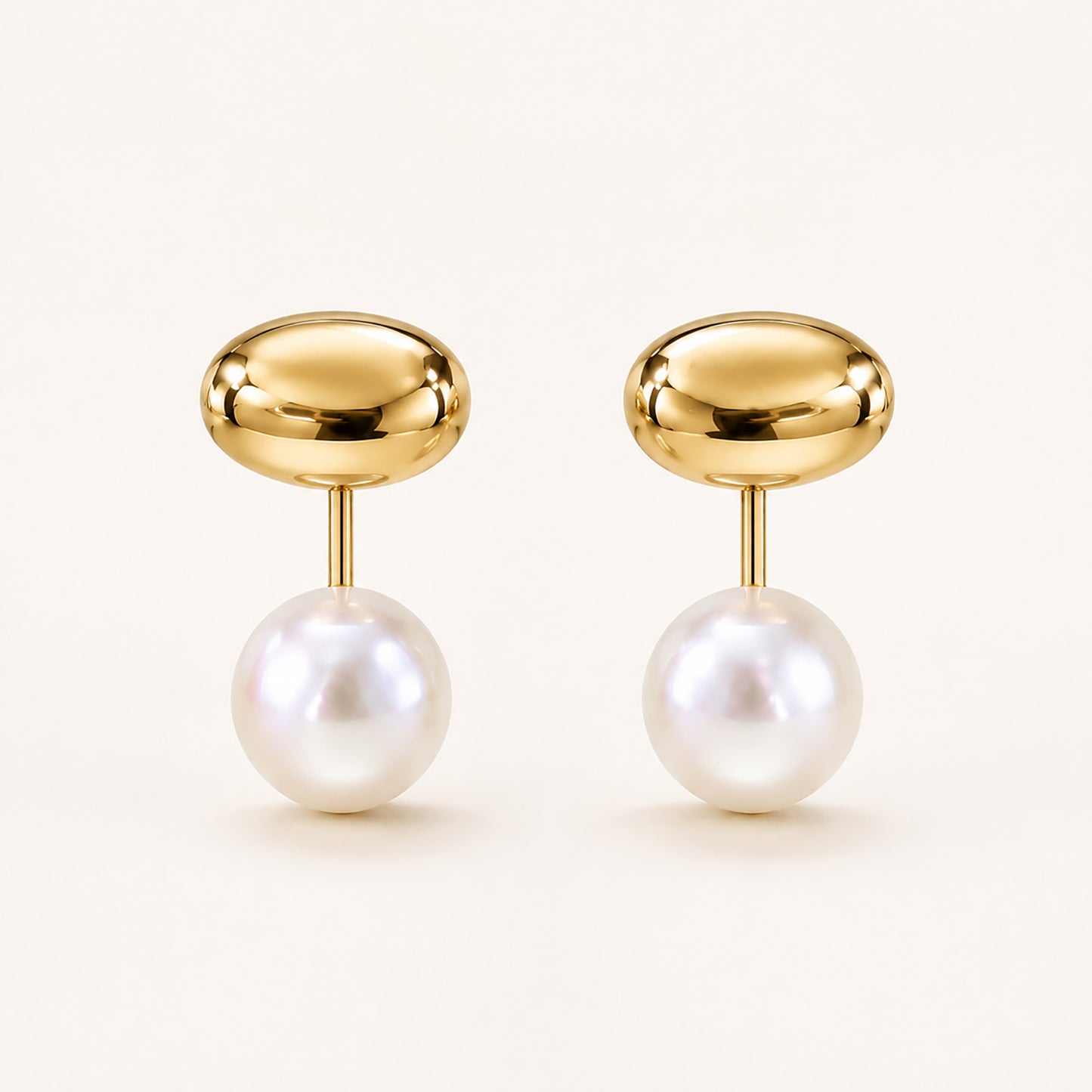 Minimalist front-back stud earrings featuring a polished gold-tone bean and a freshwater pearl drop on a clean white background.