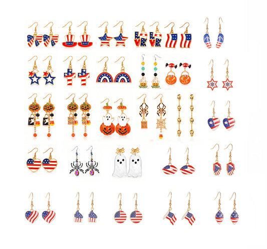 Flatlay of 28 pairs Halloween and patriotic drop dangle earrings set with ghost pumpkins and USA flag hearts