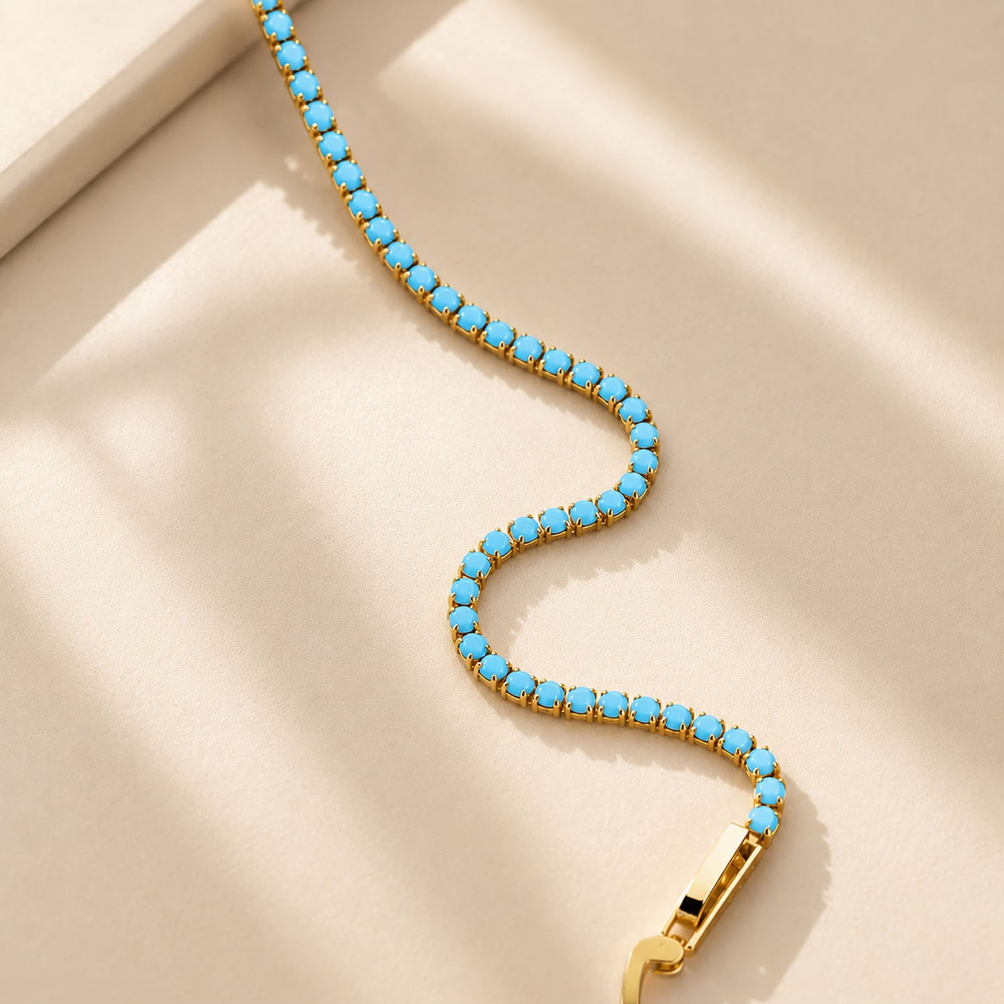 Flexible-K-gold-finished-copper-tennis-bracelet-with-minimalist-turquoise-stones-showing-premium-jewelry-details