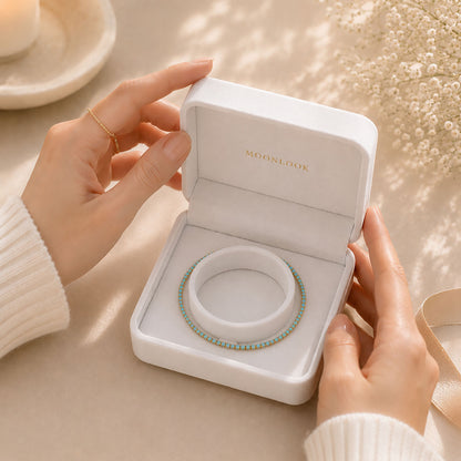 Premium-gift-ready-white-jewelry-box-presenting-a-minimalist-turquoise-tennis-bracelet-for-elegant-gifting