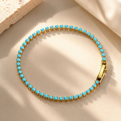 Vibrant-turquoise-tennis-chain-bracelet-arranged-in-a-circle-on-an-aesthetic-warm-sand-background