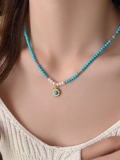 Model showcasing bohemian style turquoise bead necklace resting along collarbone