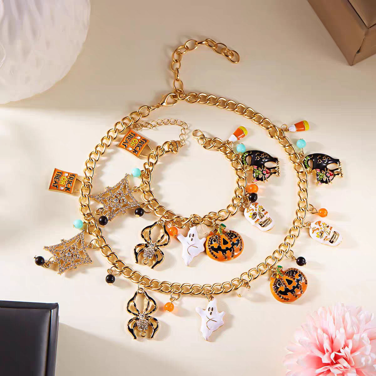 Gold-tone Halloween charm necklace and bracelet matching set displayed on light background