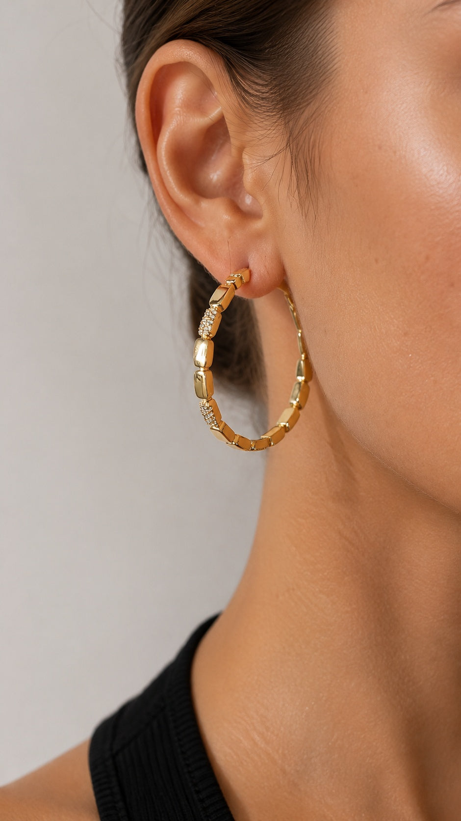 Model with braided hair wearing textured 3.8cm gold hoop earrings with sparkling cz crystals