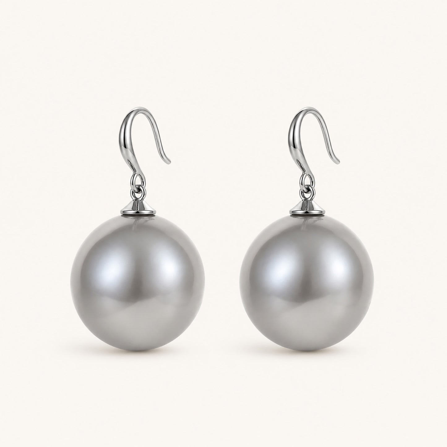 Clean studio shot of bold silver-tone drop earrings featuring 19mm oversized grey pearls on a white background.