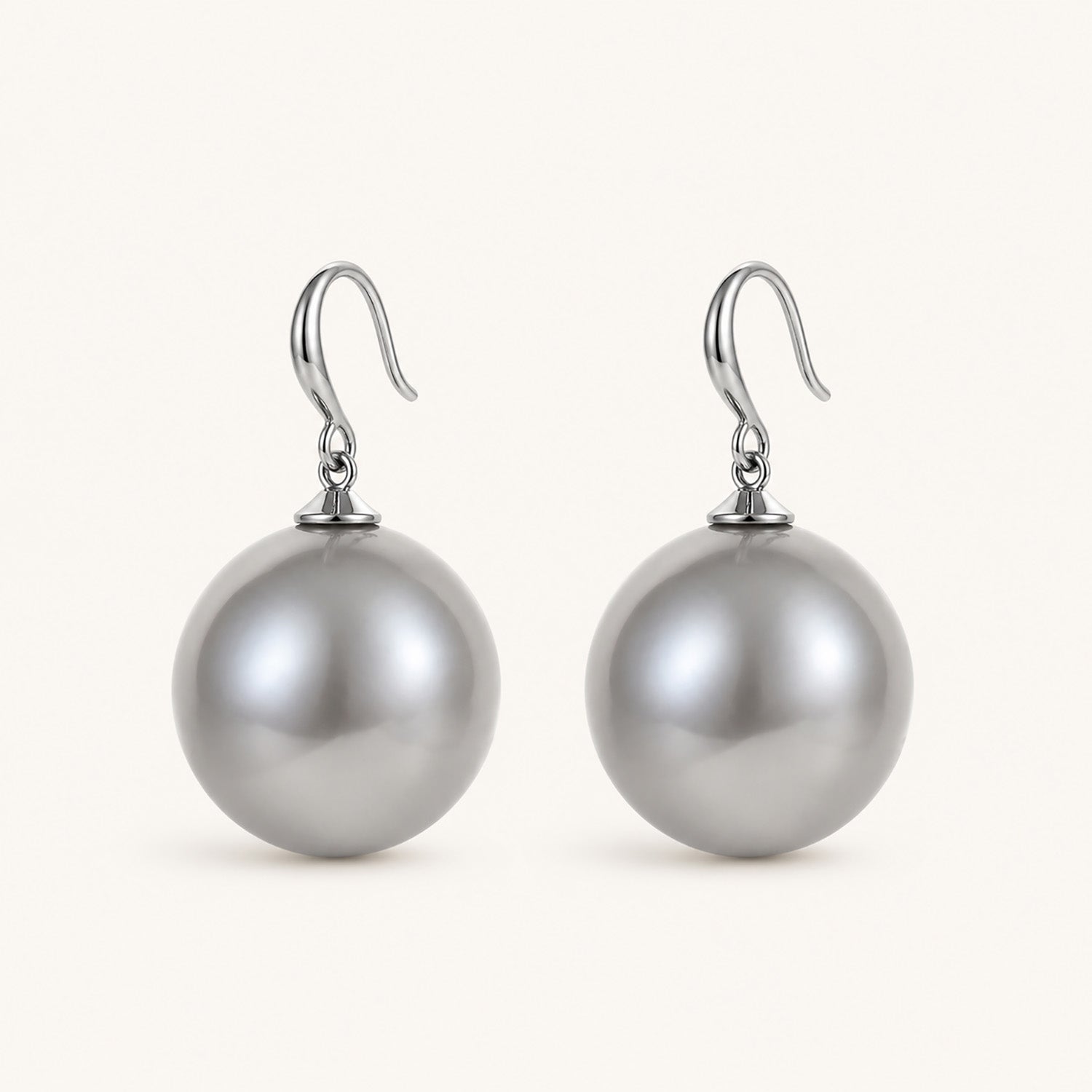 Clean studio shot of bold silver-tone drop earrings featuring 19mm oversized grey pearls on a white background.