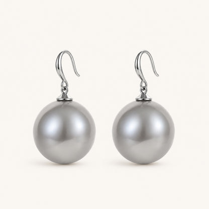 Clean studio shot of bold silver-tone drop earrings featuring 19mm oversized grey pearls on a white background.