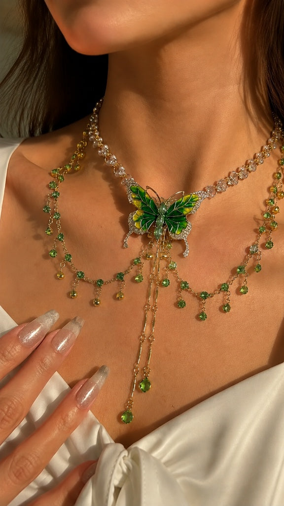Macro close-up of a stunning lariat necklace highlighting intricate green butterfly wing details, cubic zirconia, and fluid crystal drops resting beautifully against bare skin.