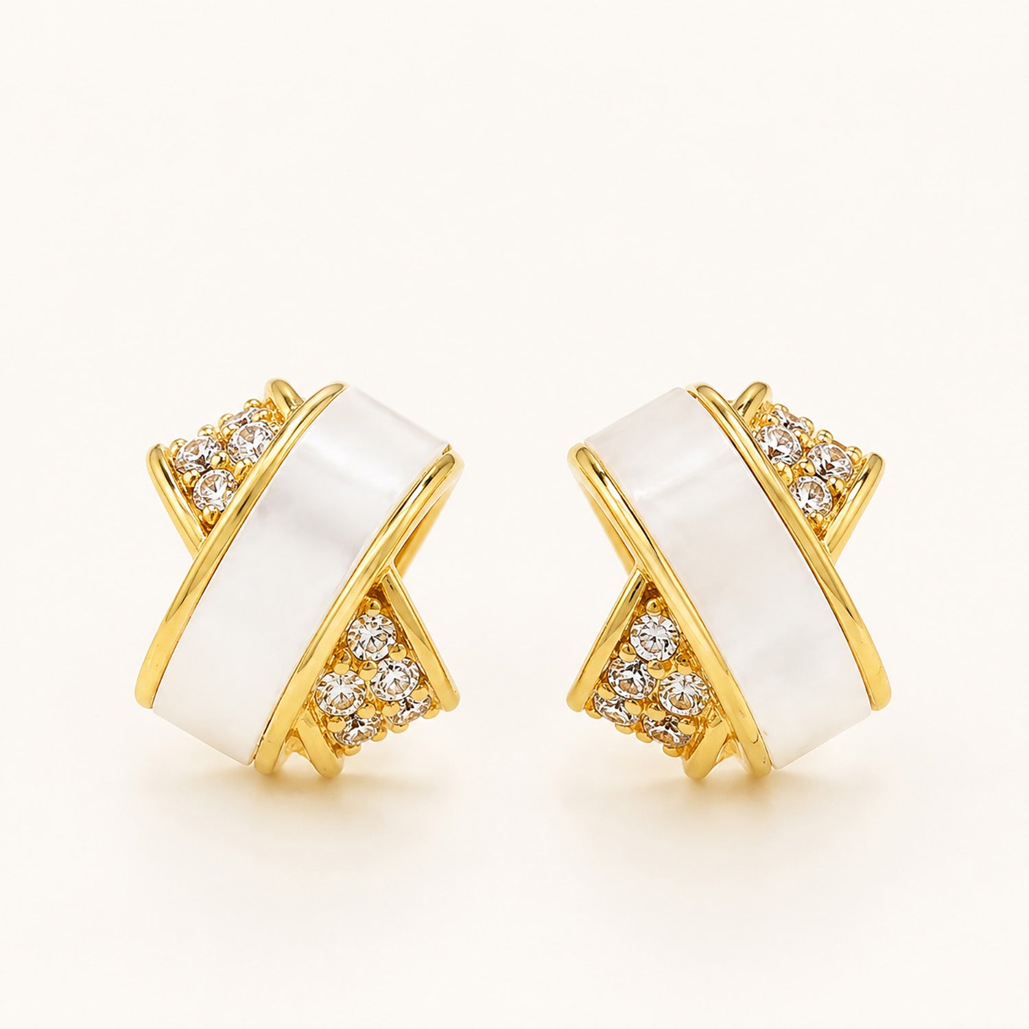 Minimalist gold-tone criss-cross double-layer stud earrings with zirconia on a clean white background.
