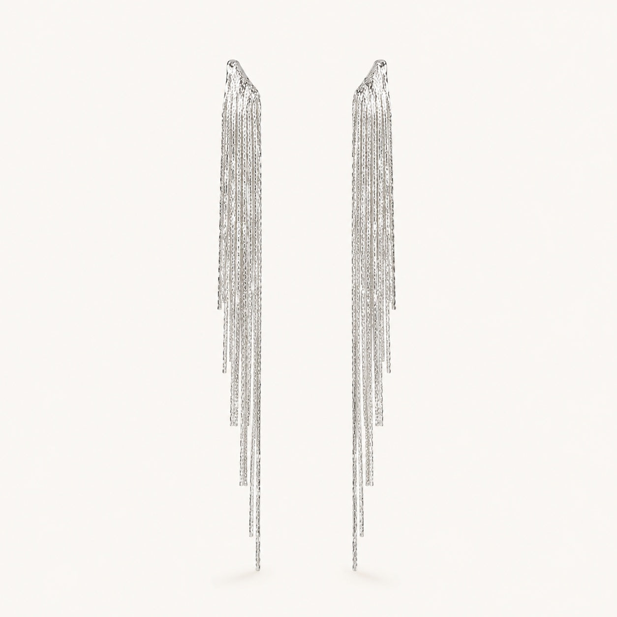 Front view of platinum plated crystal waterfall tassel drop earrings with irregular multi-strand fringe.