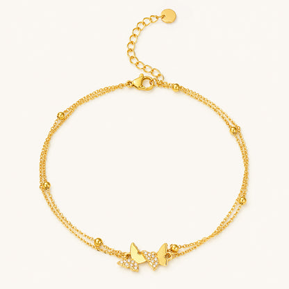 Minimalist double-layer gold-tone anklet featuring sparkling zirconia butterflies on a clean white background.