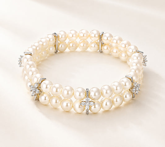 Minimalist white gold-tone double-layer pearl bracelet with zirconia accents on a white background.