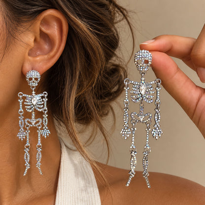 Model holding silver full crystal pave skeleton dangle earring against skin