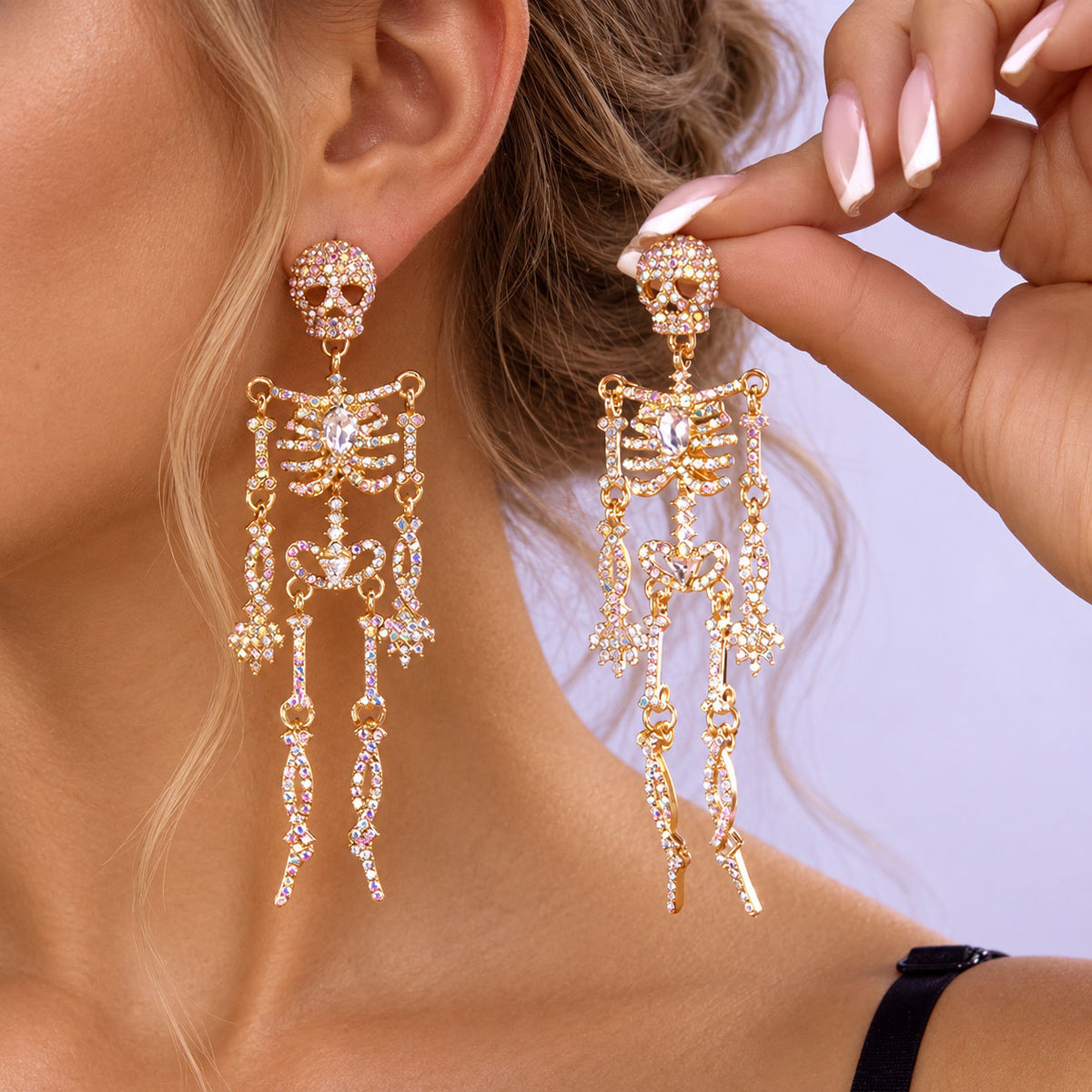 Model holding full-body crystal gold skeleton earring showcasing articulated joint movement