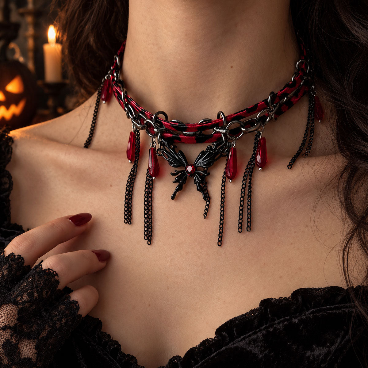 Model wearing edgy gothic butterfly tassel choker with lace gloves and dark burgundy lips