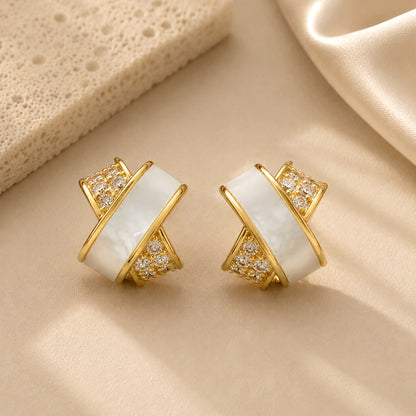 Elegant gold-tone criss-cross stud earrings featuring sparkling zirconia details.