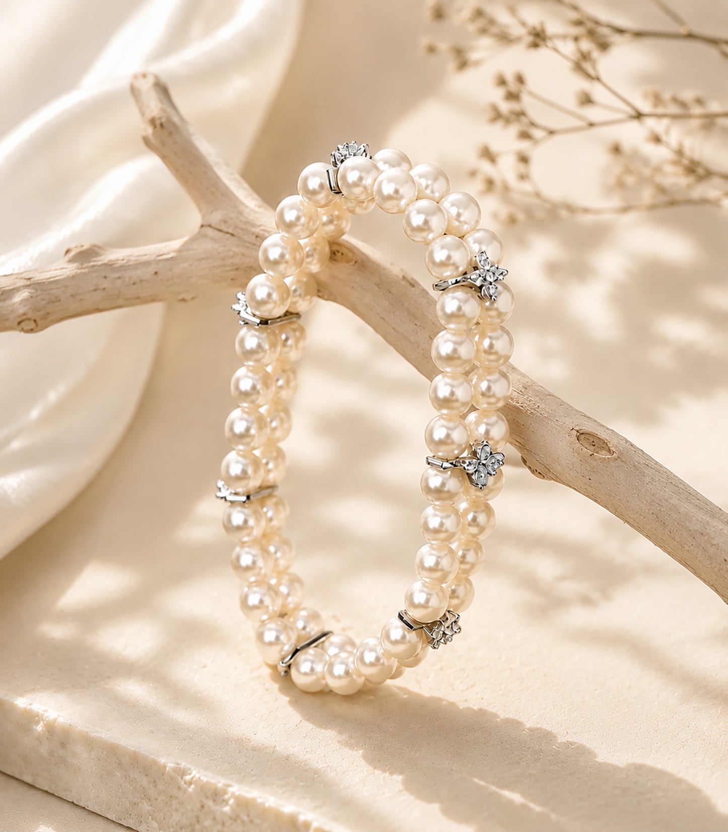 Elegant double-layer aurora pearl bracelet draped over natural driftwood.
