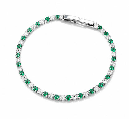 Detailed view of an elegant emerald green and clear zirconia tennis bracelet in a white gold-tone finish.