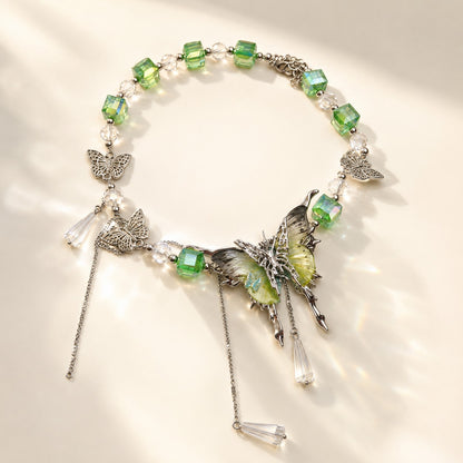 Fairycore green crystal beaded choker with large butterfly pendant and cascading drops on flat background