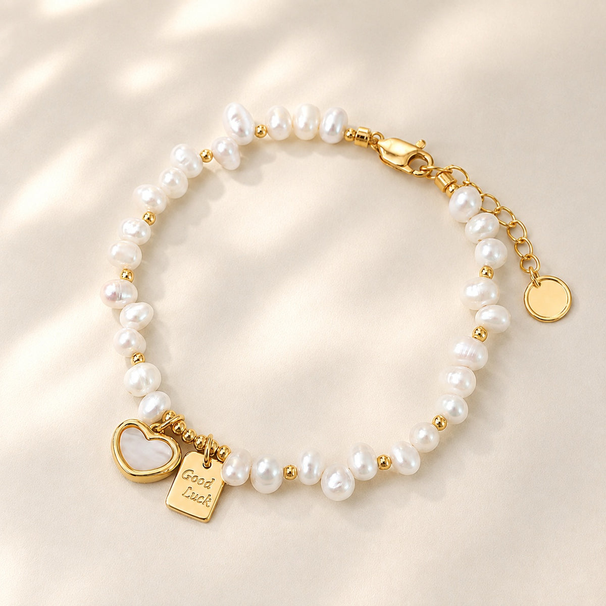 18K gold plated freshwater pearl beaded bracelet with mother of pearl heart and engraved Good Luck charm tag