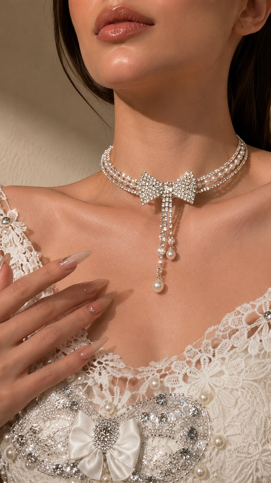Side view detail of model wearing triple-strand rhinestone bow pearl choker for evening party look