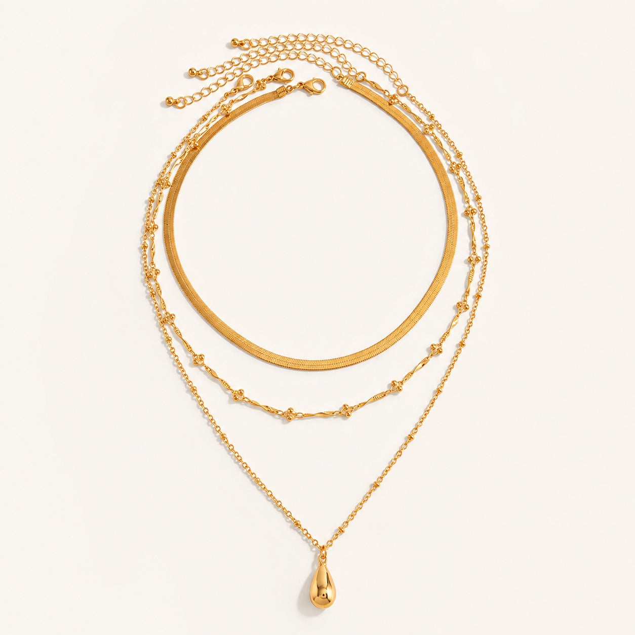Gold 3 piece layered necklace set featuring herringbone snake chain and teardrop pendant