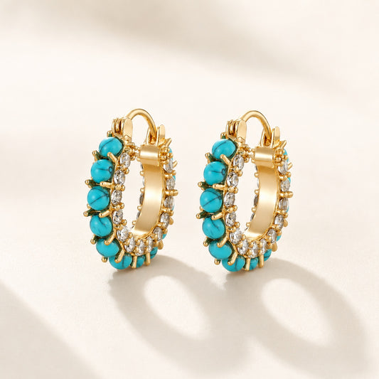 Flatlay view of pair of 2cm gold plated turquoise bead and pave cz hoop earrings