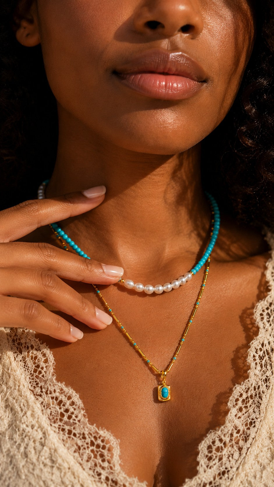 Model wearing coastal boho layered turquoise and pearl pendant necklace with lace dress