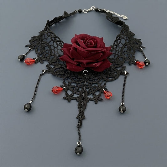 Gothic black lace choker necklace with dark red velvet rose and cascading crimson crystal beads on grey background