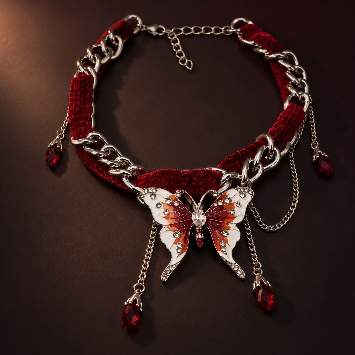 Gothic crimson red velvet choker intertwined with silver chain and enamel butterfly pendant on dark background