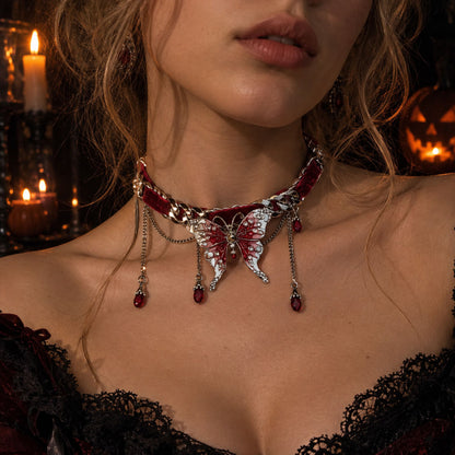 Model wearing vampire-style red velvet butterfly choker with candlelit Halloween pumpkin background