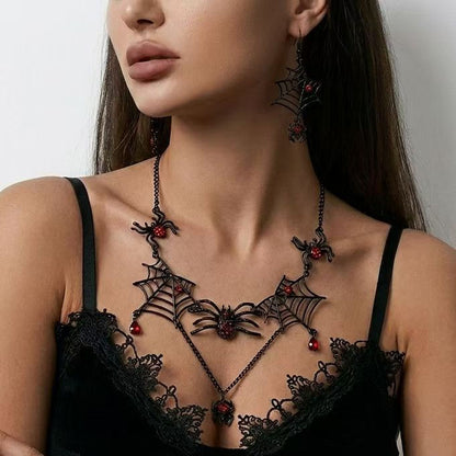 Model wearing black spiderweb choker necklace with dangling red teardrop crystals and matching spider earrings