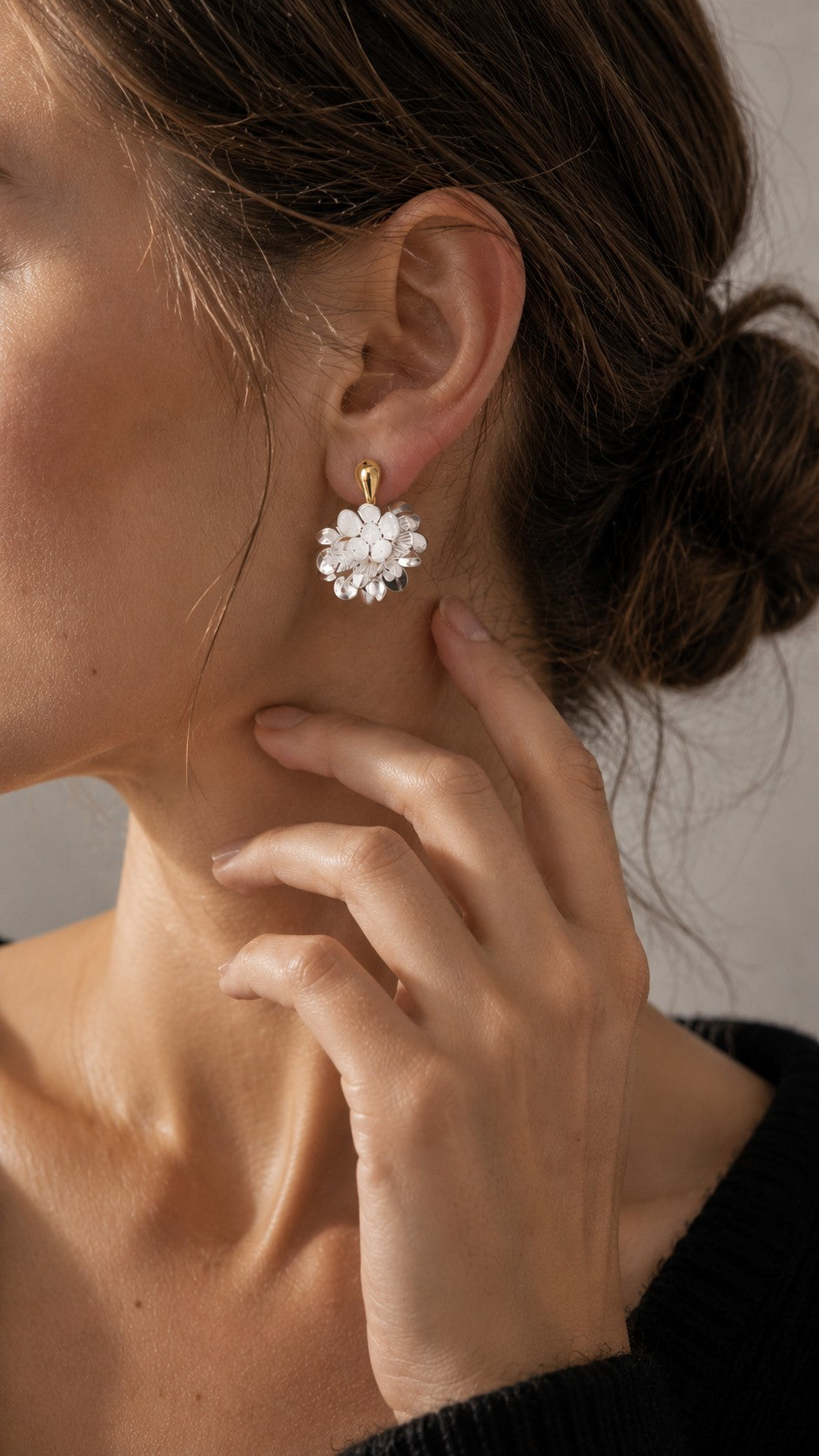 Model wearing black sweater showcasing 925 silver post two-tone flower cluster drop earring