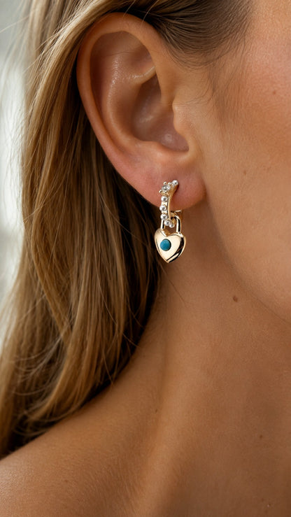Close up of model wearing dainty 25mm gold turquoise heart lock pearl drop earring