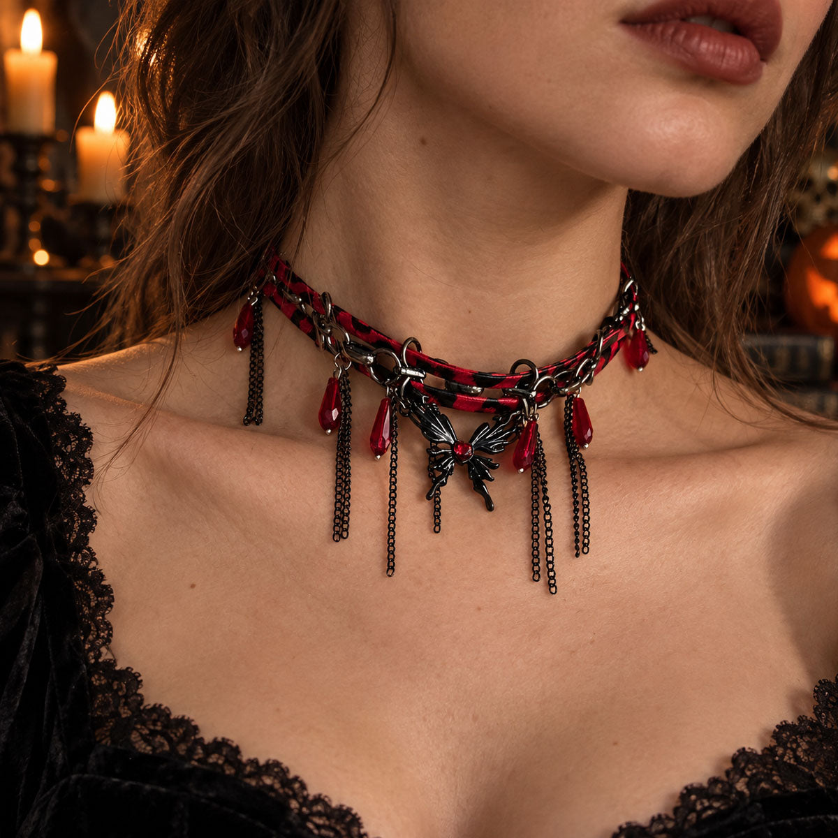 Model wearing gothic red and black leather chain butterfly choker with dark lace corset dress