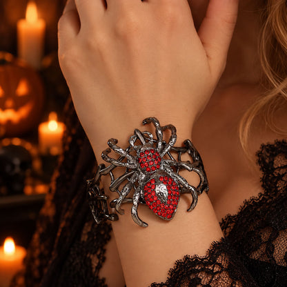 Model wearing gothic crimson rhinestone spiderweb stretch bracelet with black lace sleeve