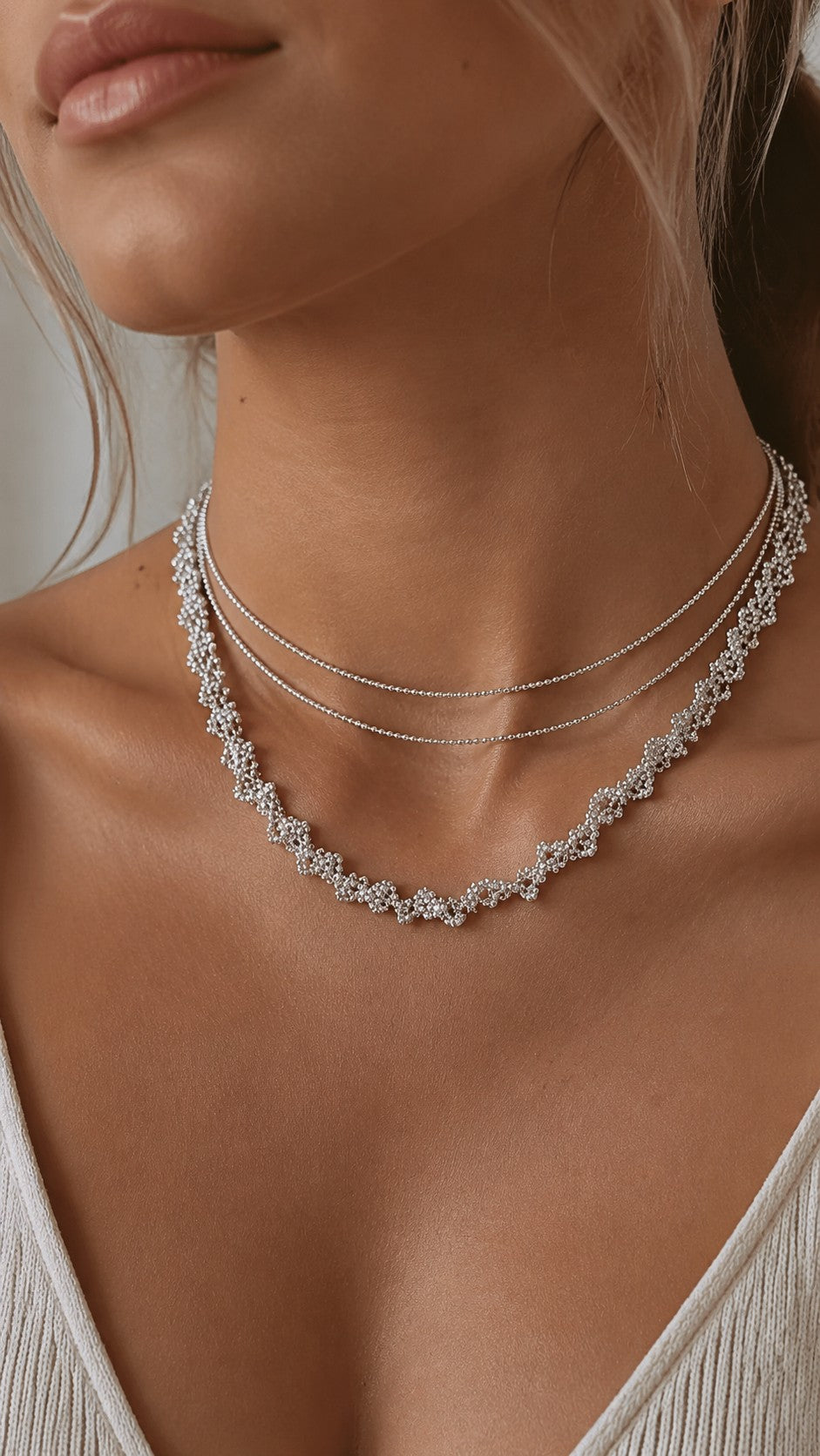 Close-up of model wearing platinum plated lace cubic zirconia necklace wrapped as a double-layer choker
