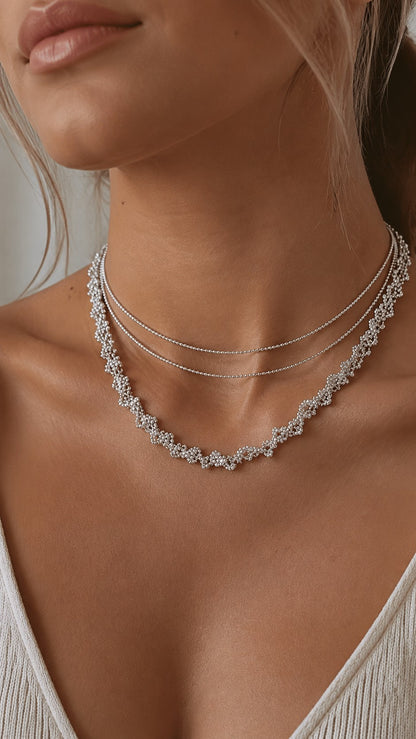 Close-up of model wearing platinum plated lace cubic zirconia necklace wrapped as a double-layer choker