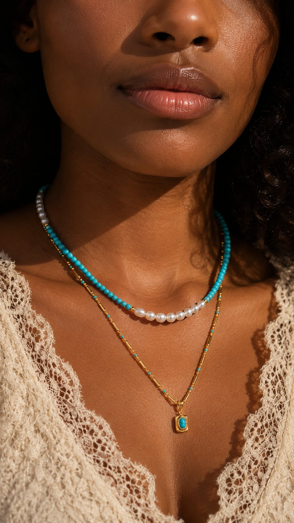 Close up of model collarbone wearing 18k gold layered turquoise and pearl beaded necklace set