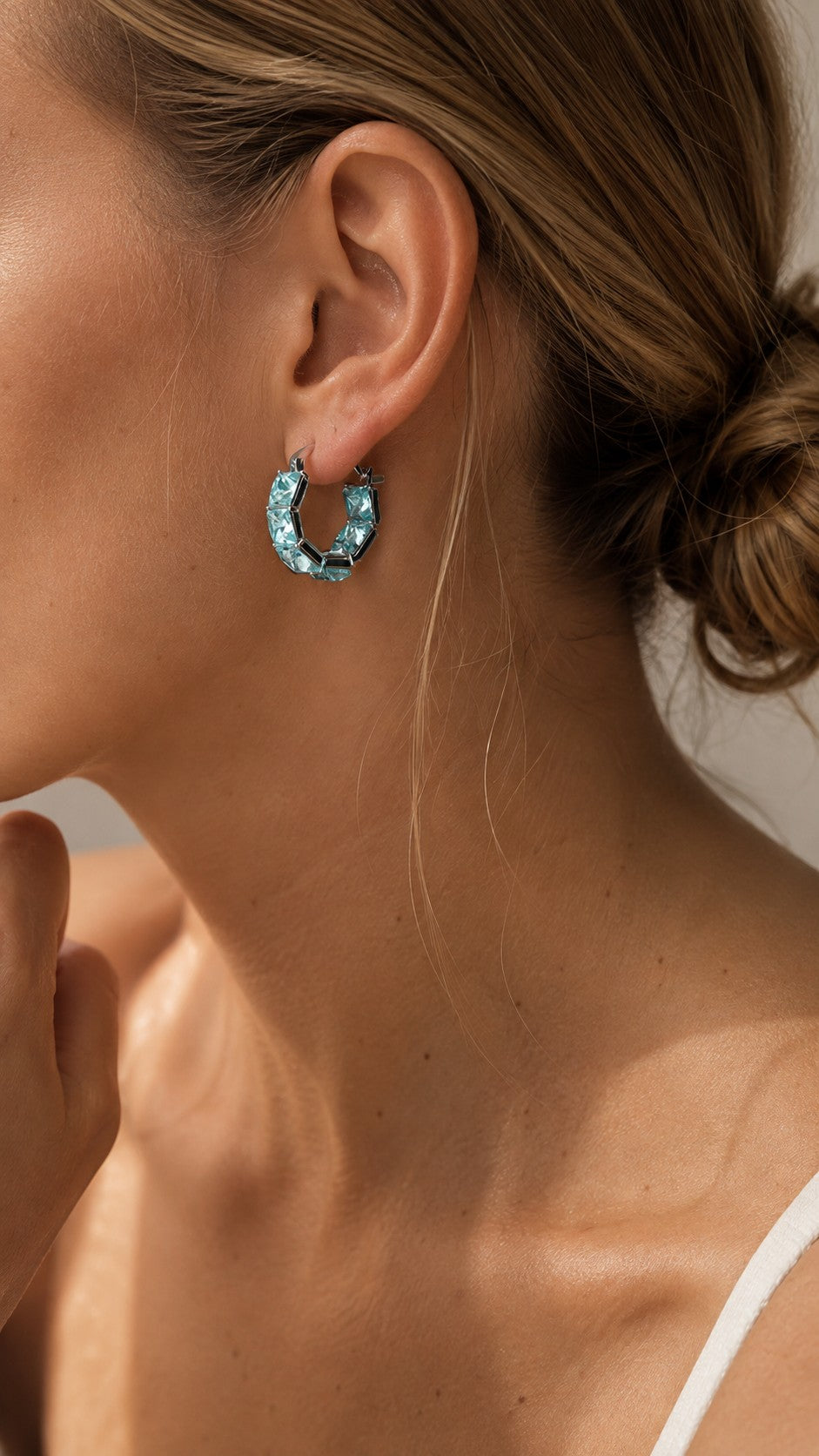 Side profile close-up of model with hair in a bun wearing 2cm ice blue square CZ hoop earrings