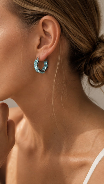 Side profile close-up of model with hair in a bun wearing 2cm ice blue square CZ hoop earrings