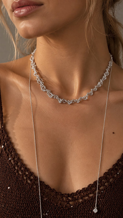 Close-up of model showcasing long silver slider chain drop with crystal end cap details