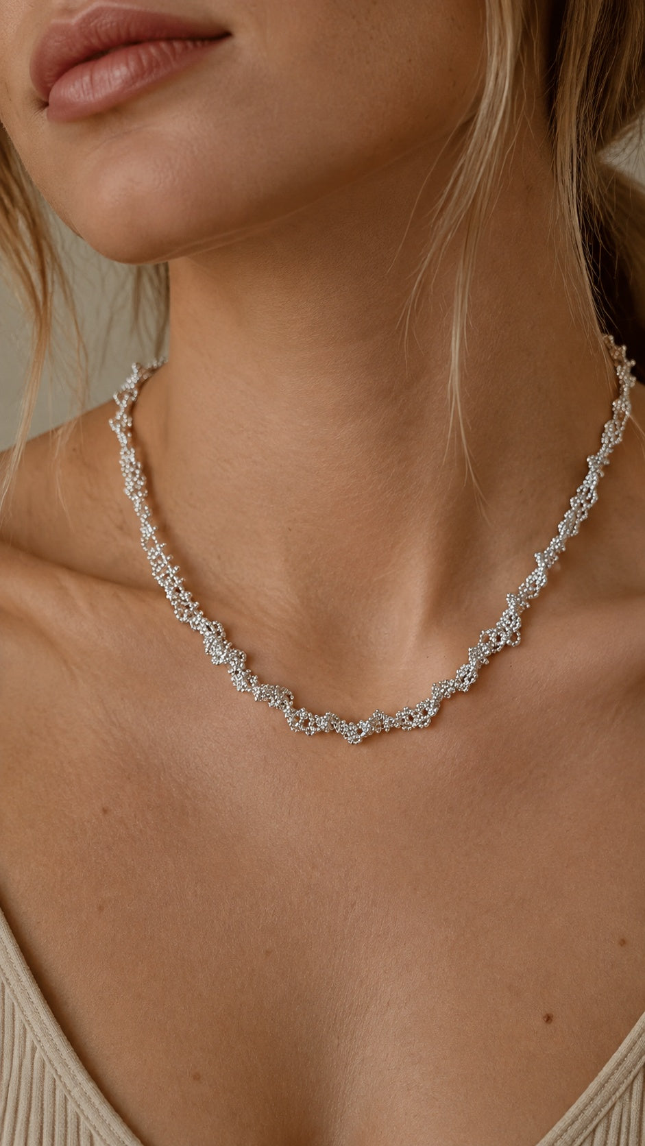 Model wearing single layer silver lace pattern short necklace highlighting cubic zirconia sparkle
