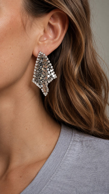 Close up of model wearing 4.3cm silver liquid metal mesh scarf rhombus stud earrings with grey top