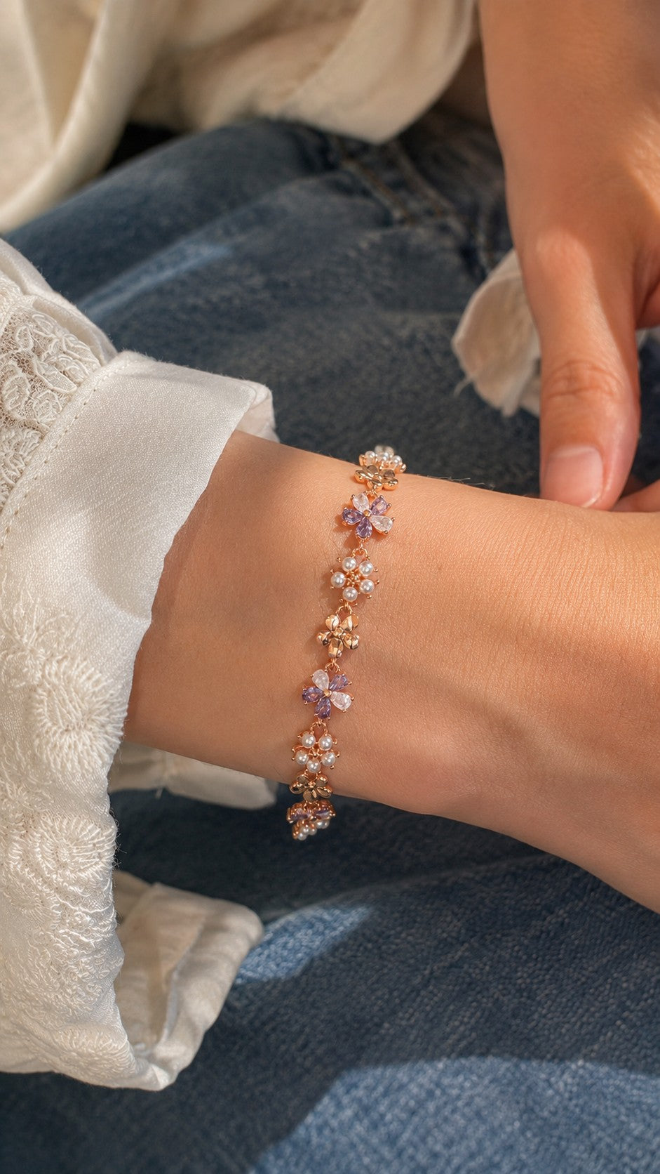 Model wearing 17cm rose gold purple crystal and pearl flower bracelet with white lace top