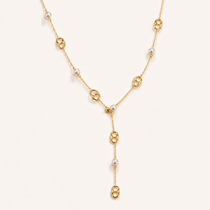 Elegant gold-tone lariat necklace featuring mother-of-pearl and anchor links on a white background.