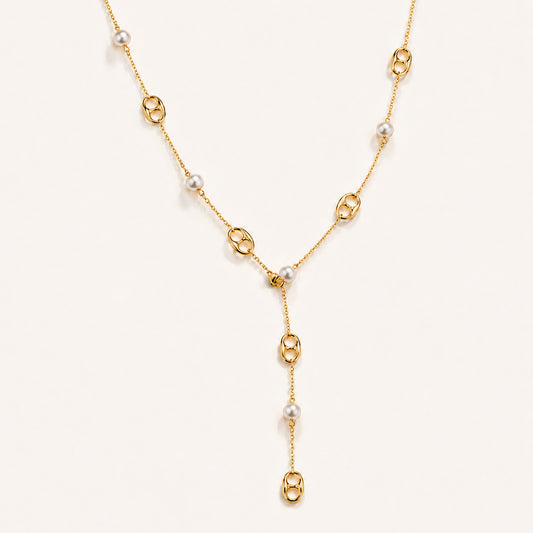 Elegant gold-tone lariat necklace featuring mother-of-pearl and anchor links on a white background.